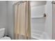 Clean bathroom with a tub and shower combo featuring white subway tiles and neutral color scheme at 6622 Cardiff Cir, McCordsville, IN 46055