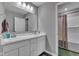 Bright bathroom with double vanity, spacious mirror, and access to a shower-tub combo at 6622 Cardiff Cir, McCordsville, IN 46055