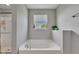 Relaxing soaking tub with a window view and a separate shower at 6622 Cardiff Cir, McCordsville, IN 46055
