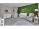 A charming Bedroom with an accent wall, a white crib, and an alphabet rug on plush carpet at 6622 Cardiff Cir, McCordsville, IN 46055