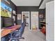 Cozy bedroom with dark walls, plush carpet, and an ensuite bathroom, designed for gaming and relaxation at 6622 Cardiff Cir, McCordsville, IN 46055