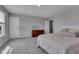 Bright bedroom features soft carpet, a dresser with a TV, and natural light from the windows at 6622 Cardiff Cir, McCordsville, IN 46055