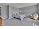 A neutral toned bedroom featuring plush carpet, a cozy armchair and an inviting aesthetic at 6622 Cardiff Cir, McCordsville, IN 46055