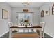 Bright dining area with a view of the backyard, furnished with a wooden table, chairs, and a bench at 6622 Cardiff Cir, McCordsville, IN 46055
