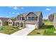 Attractive two-story house with a blue facade, a gray roof and an attached two-car garage, plus a lovely yard at 6622 Cardiff Cir, McCordsville, IN 46055