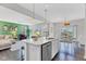 Open-concept kitchen with a large island, stainless steel dishwasher, and views into the living and dining areas at 6622 Cardiff Cir, McCordsville, IN 46055