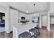 Modern kitchen featuring white cabinets, quartz countertops, stainless steel appliances, and a center island at 6622 Cardiff Cir, McCordsville, IN 46055