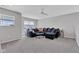 Spacious living room with plush sectional sofa, neutral carpet, and modern ceiling fan, perfect for relaxing at 6622 Cardiff Cir, McCordsville, IN 46055