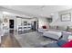 Open-concept living space with a gray sectional, a sleek kitchen with stainless steel appliances, and dark wood floors at 6622 Cardiff Cir, McCordsville, IN 46055
