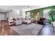 Bright and airy living room featuring a comfortable sectional sofa, stylish rug, and a staircase leading upstairs at 6622 Cardiff Cir, McCordsville, IN 46055
