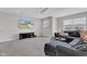 Comfortable living room with large sectional, TV, and natural light, creating a welcoming space for relaxation at 6622 Cardiff Cir, McCordsville, IN 46055