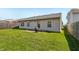 Exterior shot of a cozy backyard with a well-maintained lawn and a patio area perfect for outdoor gatherings at 7048 Tassel Meadow Dr, Indianapolis, IN 46217