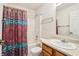 A bright bathroom with a colorful shower curtain and updated vanity at 7048 Tassel Meadow Dr, Indianapolis, IN 46217