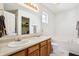 Bright bathroom with double sinks, wood cabinets, and a separate tub at 7048 Tassel Meadow Dr, Indianapolis, IN 46217