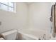 Bright bathroom showcasing a large soaking tub and a towel rack at 7048 Tassel Meadow Dr, Indianapolis, IN 46217