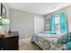 Comfortable bedroom featuring neutral walls, closet and modern turquoise accents at 7048 Tassel Meadow Dr, Indianapolis, IN 46217
