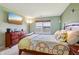 Well-lit bedroom with wood furniture, a window, and a mounted television at 7048 Tassel Meadow Dr, Indianapolis, IN 46217