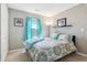 Cozy bedroom is styled with modern gray walls and bright turquoise accents at 7048 Tassel Meadow Dr, Indianapolis, IN 46217