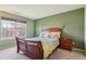 Bright bedroom featuring a wooden bed frame, bedside table, and a window with natural light at 7048 Tassel Meadow Dr, Indianapolis, IN 46217