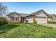 Attractive single-Gathering home with a well-manicured lawn and attached two-car garage at 7048 Tassel Meadow Dr, Indianapolis, IN 46217