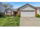 Charming single-story home featuring a two-car garage and well-maintained front yard at 7048 Tassel Meadow Dr, Indianapolis, IN 46217