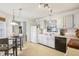 Open kitchen featuring white cabinets, modern appliances, and a cozy breakfast area at 7048 Tassel Meadow Dr, Indianapolis, IN 46217