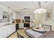 Well-lit kitchen with white cabinets, black appliances, and adjacent breakfast nook at 7048 Tassel Meadow Dr, Indianapolis, IN 46217