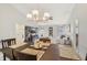 Open-concept living and dining area with vaulted ceilings, modern lighting, and comfortable furniture at 7048 Tassel Meadow Dr, Indianapolis, IN 46217