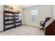 A bright office space is styled with a unique shelving and traditional desk at 7048 Tassel Meadow Dr, Indianapolis, IN 46217