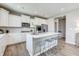 Bright kitchen with white cabinets, stainless steel appliances, a large island, and bar stool seating at 7331 Deerberg Dr, Indianapolis, IN 46259