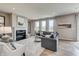 Bright living room with a fireplace, comfortable seating, and large windows at 7331 Deerberg Dr, Indianapolis, IN 46259