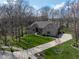 Aerial view of the home, showcasing the lush green lawn and a wide driveway at 7424 Campfire Run, Indianapolis, IN 46236
