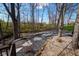 Landscaped backyard with rock path and mature trees, offering a serene outdoor space at 7424 Campfire Run, Indianapolis, IN 46236