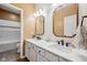 Bathroom with white shiplap walls, a double vanity with mirrors, and modern black fixtures at 7424 Campfire Run, Indianapolis, IN 46236