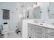 Bathroom features a modern glass shower, double vanity, and sleek design with updated fixtures at 7424 Campfire Run, Indianapolis, IN 46236