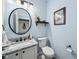 Powder room featuring a granite vanity, modern fixtures, and stylish decor accents at 7424 Campfire Run, Indianapolis, IN 46236