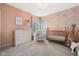 Bedroom with soft pink walls, white furniture, and a sweet giraffe, perfect for a baby at 7424 Campfire Run, Indianapolis, IN 46236