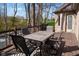 Outdoor deck with dining furniture for entertaining and enjoying the wooded views at 7424 Campfire Run, Indianapolis, IN 46236