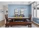 Well-lit dining room featuring a long wooden table and modern decor at 7424 Campfire Run, Indianapolis, IN 46236