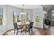 Dining area with round table, black chairs, and windows with a view of the outdoor scenery at 7424 Campfire Run, Indianapolis, IN 46236