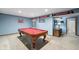 Basement game room with billiard table, adjacent bathroom, and sports memorabilia at 7424 Campfire Run, Indianapolis, IN 46236