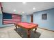 Basement game room features a pool table and Americana decor at 7424 Campfire Run, Indianapolis, IN 46236