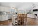 Open-concept kitchen features an island with breakfast bar, stainless appliances, and hardwood floors at 7424 Campfire Run, Indianapolis, IN 46236