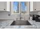 Close up of the kitchen sink area featuring granite counters and a view of the outdoors at 7424 Campfire Run, Indianapolis, IN 46236