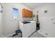 Laundry room with tile floors, window, and utility sink at 7424 Campfire Run, Indianapolis, IN 46236