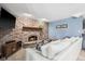 Living room with a brick fireplace and cozy seating arrangement with soft blue walls at 7424 Campfire Run, Indianapolis, IN 46236