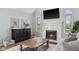 Inviting living room with fireplace, soft furnishings, and bright windows offering a view at 7424 Campfire Run, Indianapolis, IN 46236