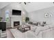 Cozy living room with fireplace, plush seating, and large windows providing plenty of natural light at 7424 Campfire Run, Indianapolis, IN 46236