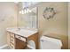 Bathroom featuring a vanity sink, mirror, decorative wreath, and a toilet at 7450 Deville Ct, Indianapolis, IN 46256