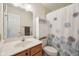 Bright bathroom with single vanity, linen cabinet, and patterned shower curtain at 7450 Deville Ct, Indianapolis, IN 46256